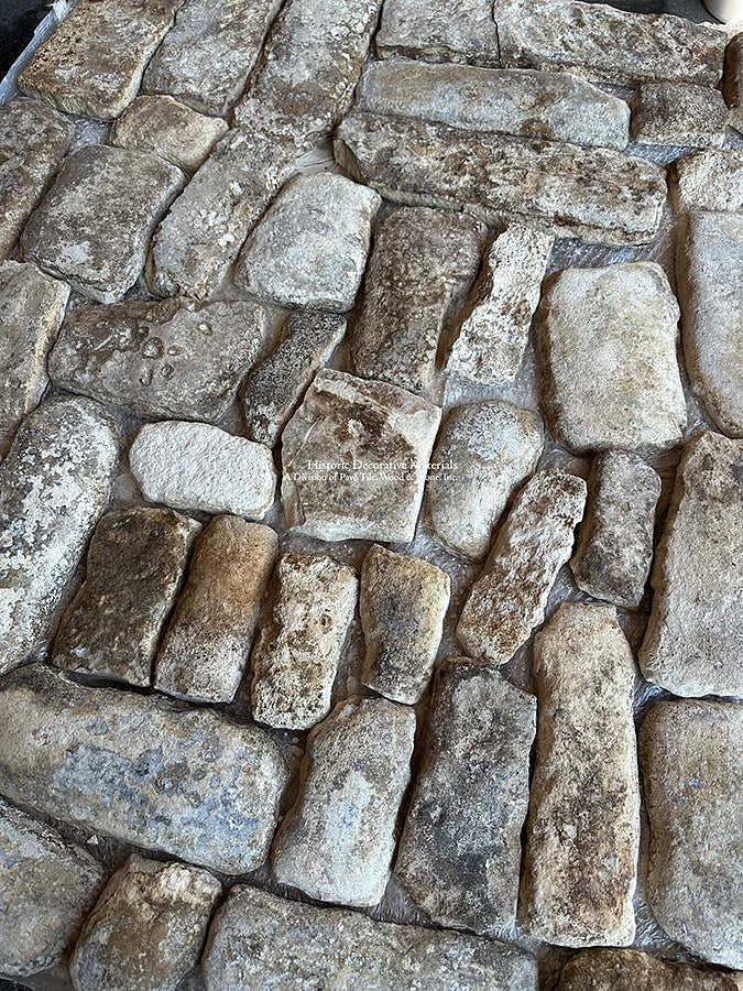 Random pattern installation is what defines an antique French limestone cobblestone pattern.
