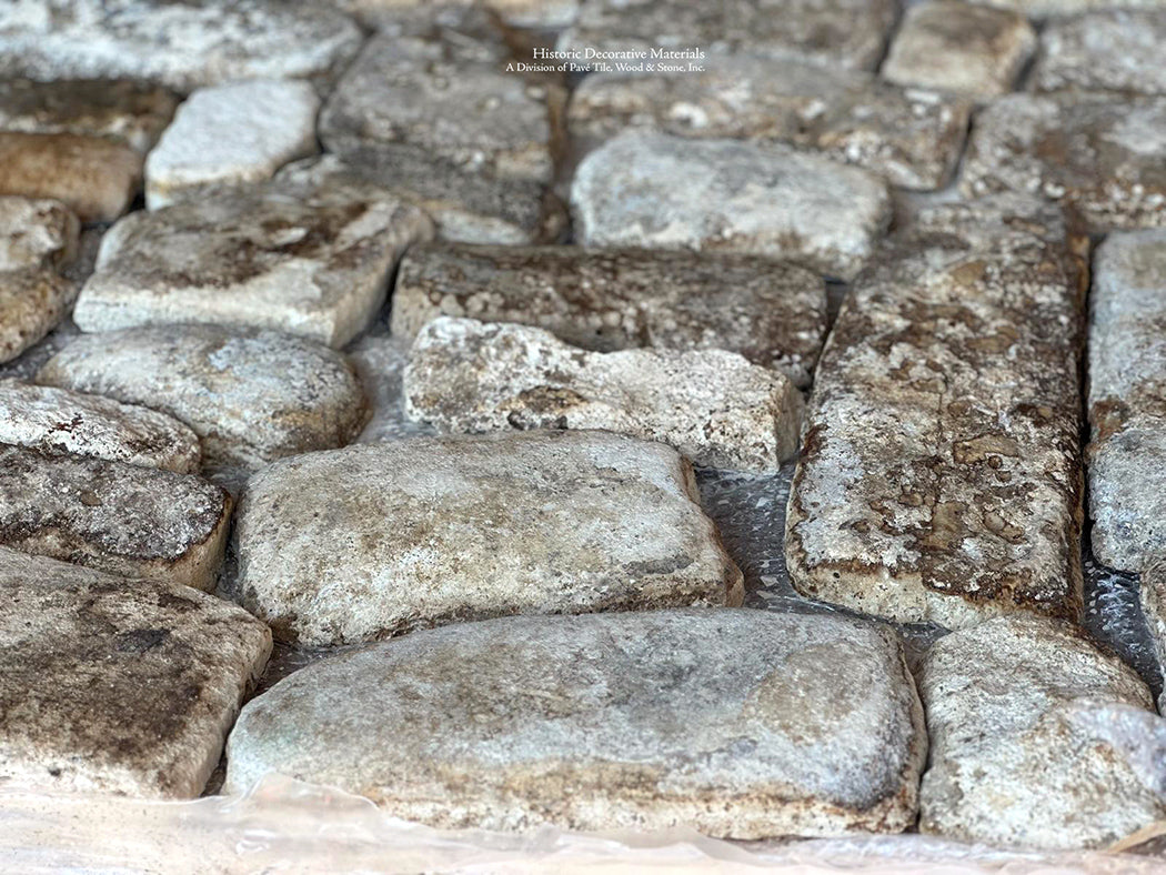 Beautiful color variations of chestnut, gray and ivory create an extraordinary antique French limestone cobblestone floor.