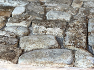 Beautiful color variations of chestnut, gray and ivory create an extraordinary antique French limestone cobblestone floor.