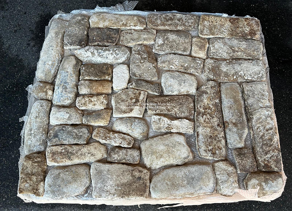 A mosaic of hand-hewn limestone shapes define these antique French limestone cobblestones.