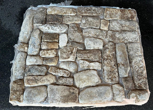 A mosaic of hand-hewn limestone shapes define these antique French limestone cobblestones.