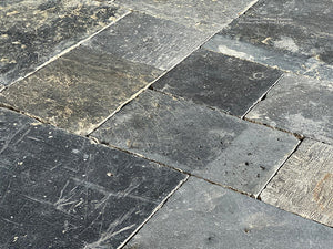 A cobblestone pattern from rectangles to squares adds incredible interest to antique Belgian bluestone floors.