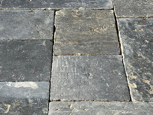 Installing antique Belgian bluestone for a kitchen floor creates an historically elegant interior.