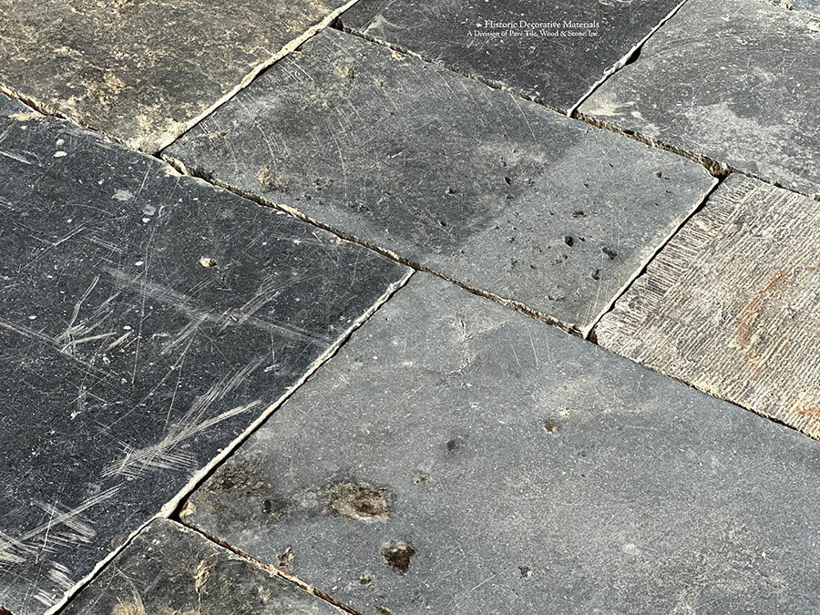 Hand-chiseled marks from 18th century Belgian masons define antique Belgian bluestone flooring.