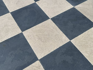 Black and beige French limestone flooring with timeworn surface and soft color variation