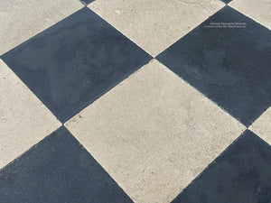 Antiqued black and beige checkerboard French limestone and ardoise stone flooring in classical European interior