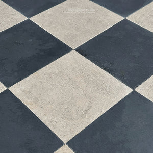 Black and beige antiqued French limestone flooring with historic patina and aged edges