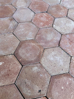 Salvaged French clay floor tiles with natural weathered surface variation