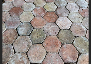 French Reclaimed Terra Cotta Tile Hexagons with worn patina create historic flooring.