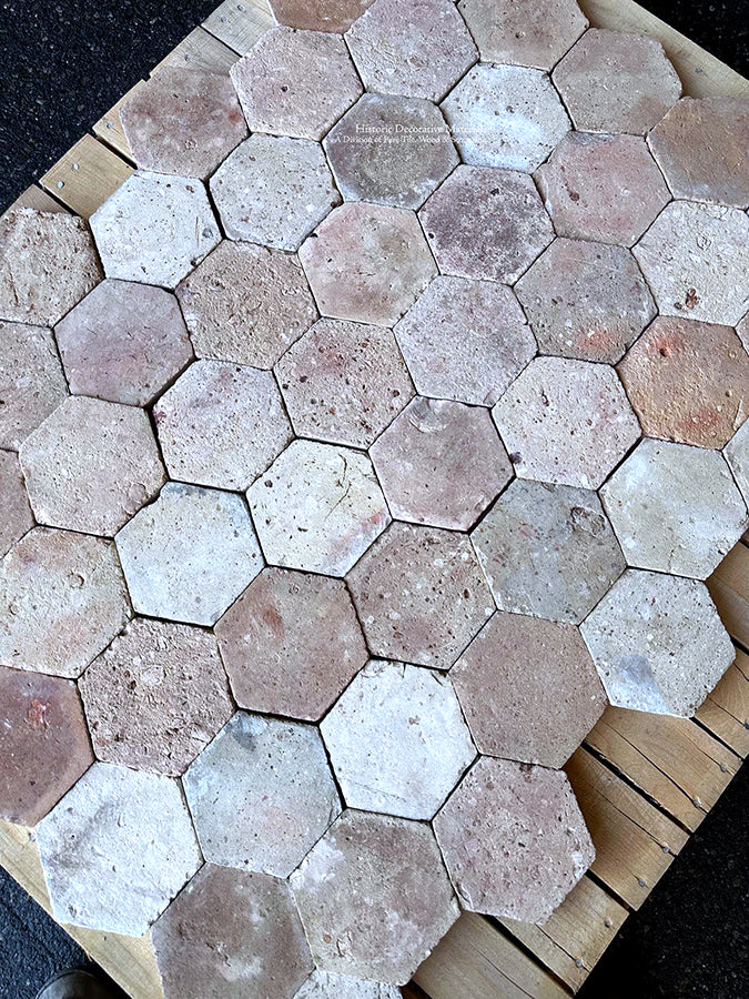 The surface texture of Le Marais French reclaimed terra cotta tiles is a worn patina.