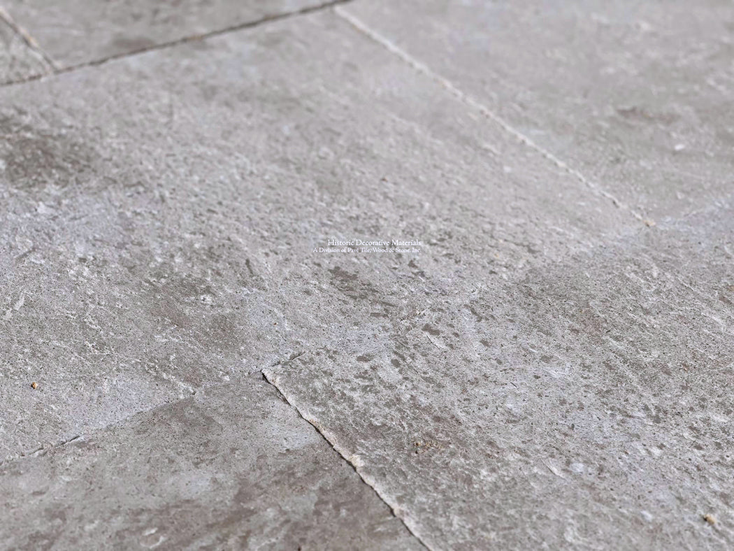 The soft patina and warm gray cream colors of antique French limestone flooring make a beautiful interior statement.