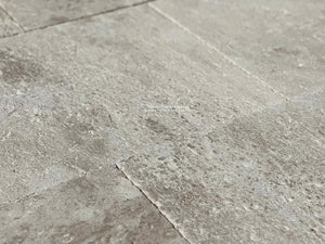 The soft patina and warm gray cream colors of antique French limestone flooring make a beautiful interior statement.