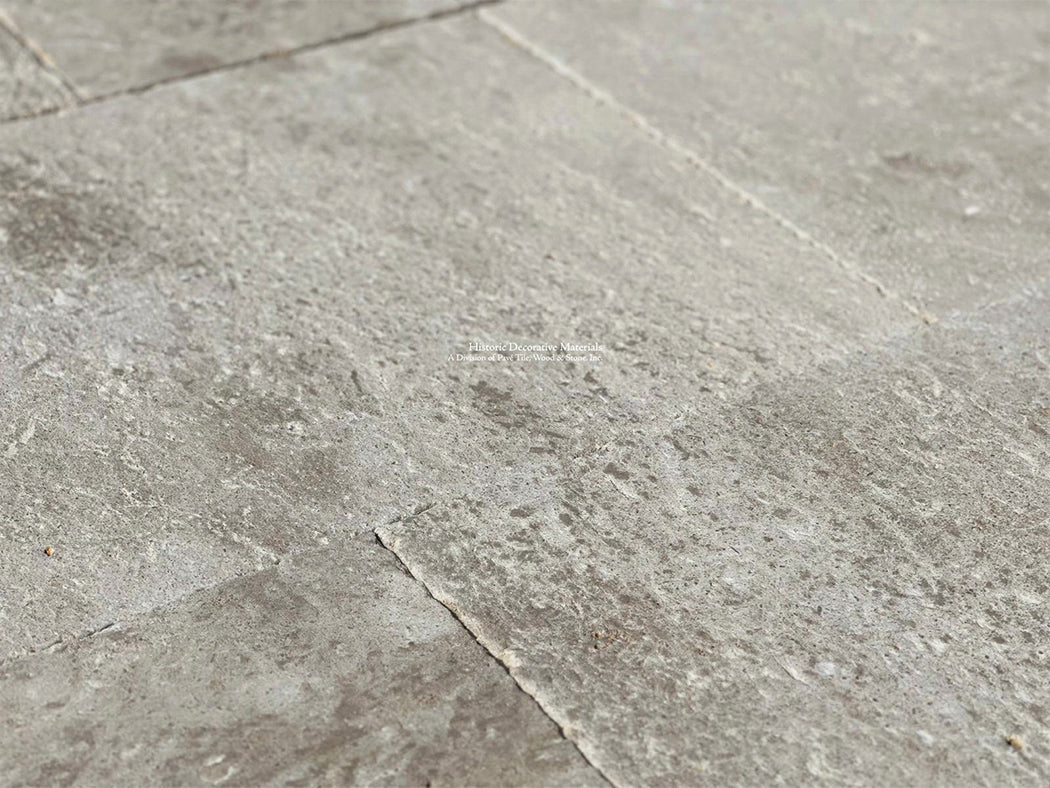 Gray and cream antique French limestone floors with hand-chiseled patina are extraordinary.