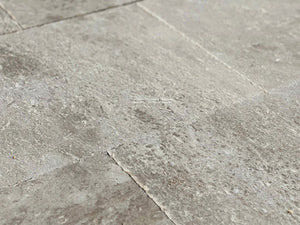 Gray and cream antique French limestone floors with hand-chiseled patina are extraordinary.