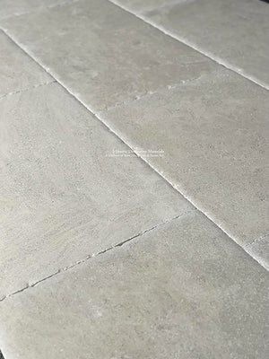 Marie-Thérèse Charlotte de France Hand-Finished Antiqued French Limestone Flooring - notice the antique edge detail - the historic provenance that anchors this limestone floor's authenticity.