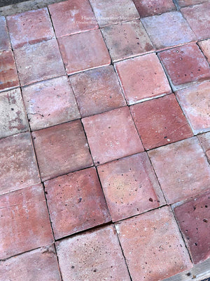 Reclaimed terra cotta flooring from France in faded rose brick red salmon and ochre tones