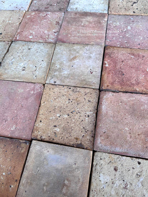 Timeworn reclaimed French terra cotta tile with handmade irregularities and historic patina for European country house interiors