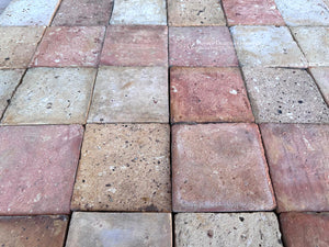 Antique French terra cotta flooring with timeworn surfaces, softened edges and pale mineral deposits from generations of use