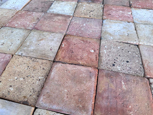Reclaimed Brittany terra cotta floor tiles in dusty rose, chalky beige and warm buff with authentic aged clay patina