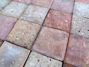 Historic French farmhouse terra cotta tile with worn handmade surfaces pairing beautifully with antiqued French oak flooring