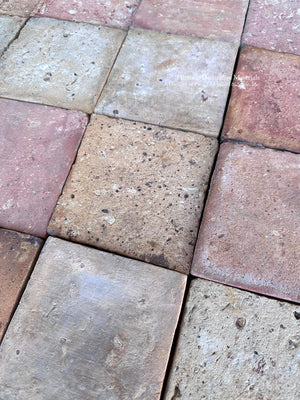 Antique French terra cotta flooring from Brittany with faded salmon and creamy stone tones paired with wide plank oak
