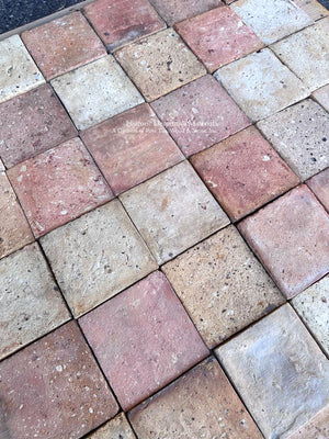 Reclaimed French farmhouse terra cotta flooring with soft rose and chalky beige tones paired with rustic French oak