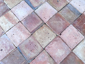 Antique French terra cotta tile with faded rose cream and weathered red patina