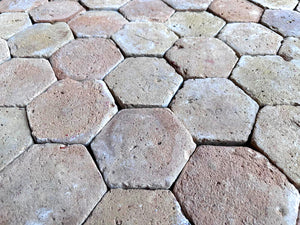 Reclaimed French terra cotta tile flooring in faded rose ochre and warm terracotta tones