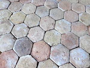 Reclaimed French terra cotta tile with centuries-old wear softened edges and natural clay patina