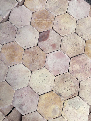 Reclaimed French terra cotta flooring with centuries-old architectural character, irregular surfaces and softened clay tones.