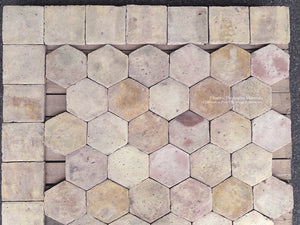 Antique French hexagon and square terra cotta tiles arranged in decorative borders and historic geometric floor patterns.