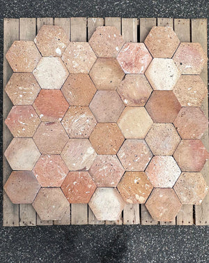 Authentic antique French terra cotta hexagonal flooring in burnt orange apricot and ivory
