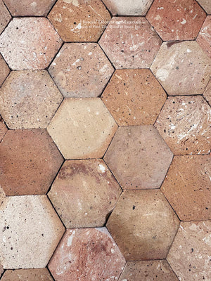 Reclaimed French clay floor tiles with naturally aged surface and patina