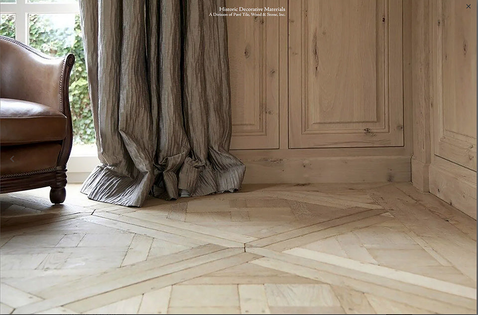 Refined interiors are heightened in beauty installing aged French oak flooring in parquet de Versailles panels