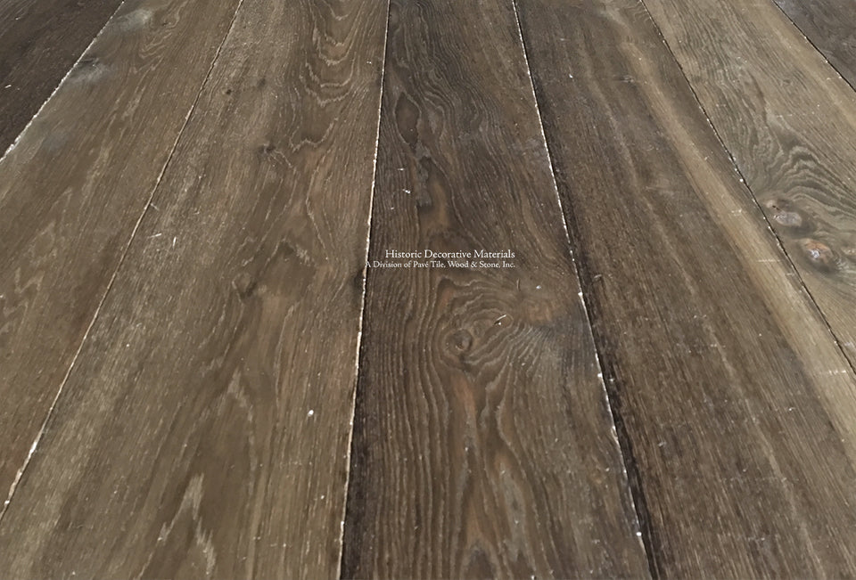 Hand finished with reclaimed patina in a walnut hue is an aged French oak floor worthy of historic homes.