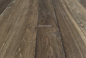 Hand finished with reclaimed patina in a walnut hue is an aged French oak floor worthy of historic homes.