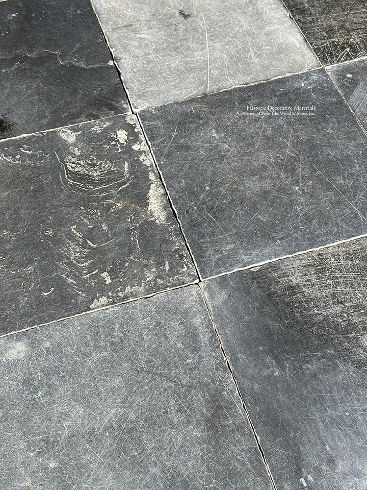 The satin patina of antique Belgian bluestone creates historic living room floors.