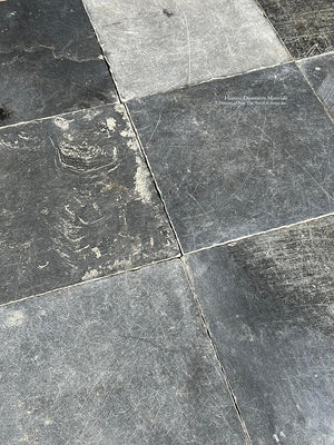 The satin patina of antique Belgian bluestone creates historic living room floors.