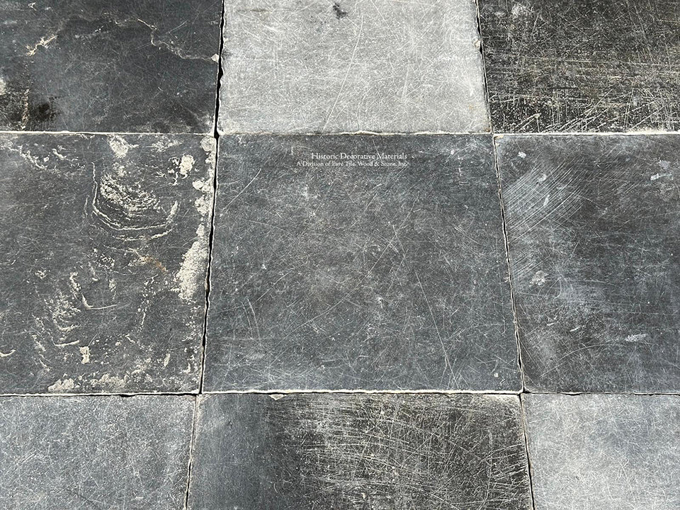 The cool marine and black blues of antique Belgian bluestone create one-of-a-kind kitchen floors.