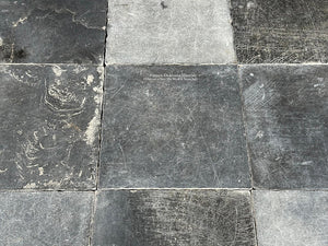 The cool marine and black blues of antique Belgian bluestone create one-of-a-kind kitchen floors.