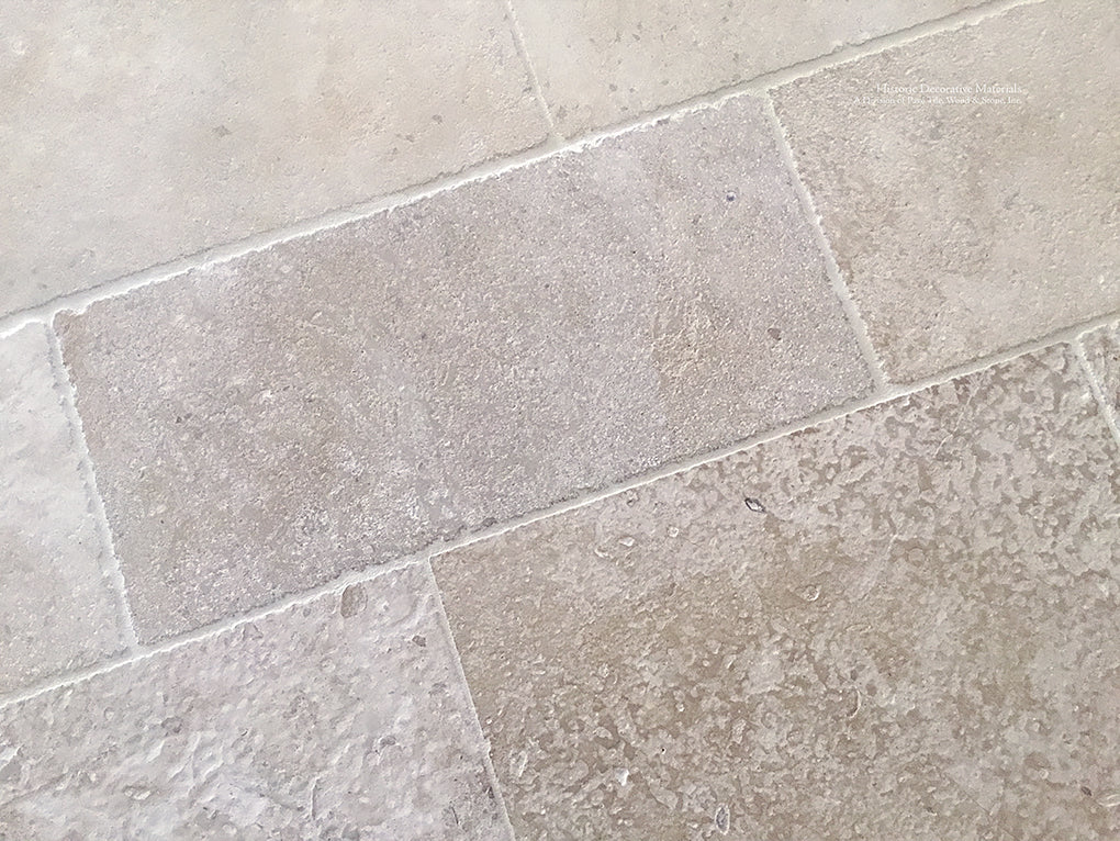 Warm ivory antique French limestone floors are soft neutrals for beautiful kitchens.
