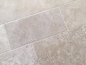 Warm ivory antique French limestone floors are soft neutrals for beautiful kitchens.