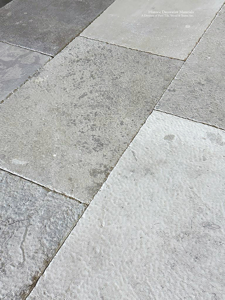Antiqued French limestone in neutral tones creates a spectacular kitchen floor.