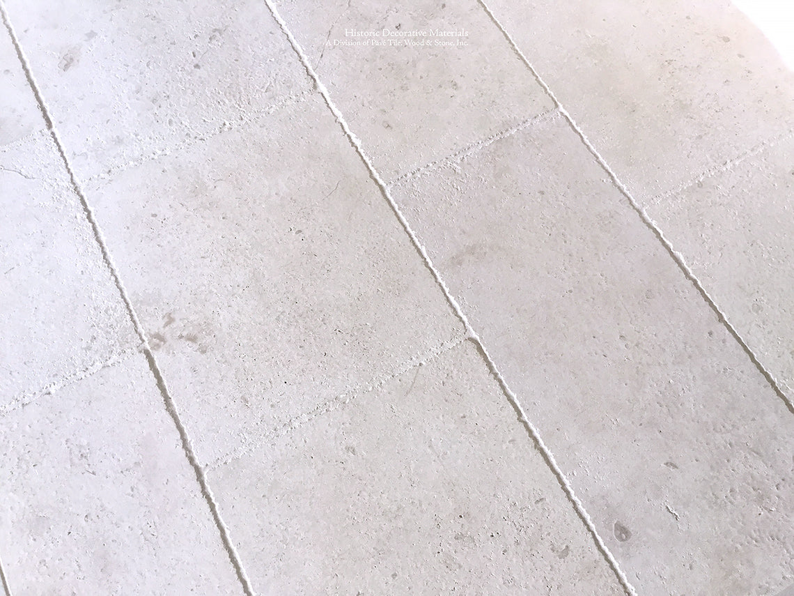 Antiqued French Limestone Floors | White Limestone adds luxury to elegant kitchens.