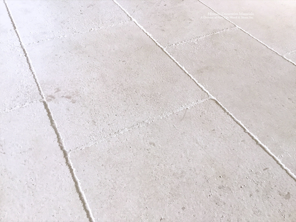 Antiqued French Limestone Flooring | Surface patina softens white limestone color palette.