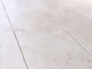 Antiqued French Limestone Flooring | Surface patina softens white limestone color palette.