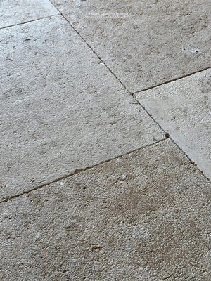 Antiqued French limestone floors in a neutral color palette will be timeless.