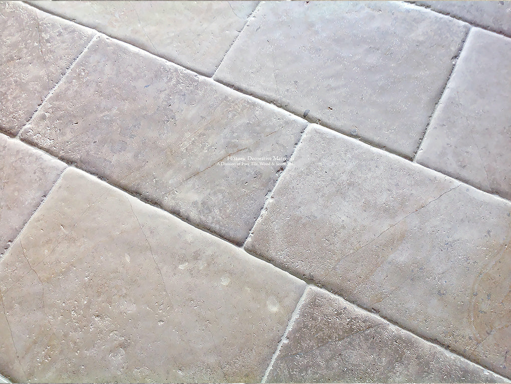 Antiqued French Limestone Flooring | Reclaimed surface patina for historic interior design.