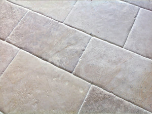 Antiqued French Limestone Flooring | Reclaimed surface patina for historic interior design.
