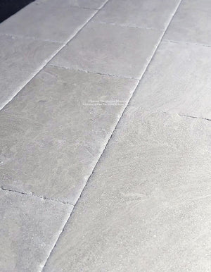 Install antique French limestone floors in vestibules and corridors for historic elegance.